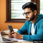 Home 19 규제준수 업무에서 발생한 문제 해결 사례 - A young Bengali man in casual office attire sitting at a tidy desk with a laptop and smartphone, set...